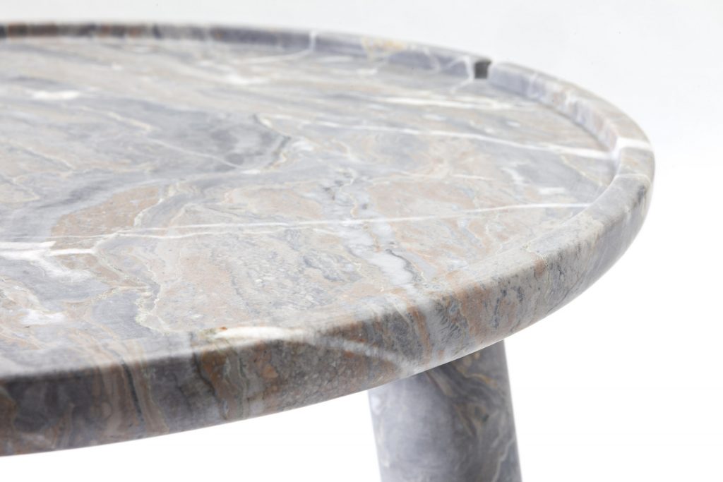 close up of large white marble stone round table