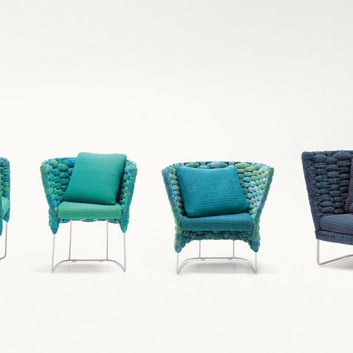 Four blue Ami Indoor Chairs, structure upholstery of woven fabric, seat cushion of fabric, structure and leg in steel on a white background.