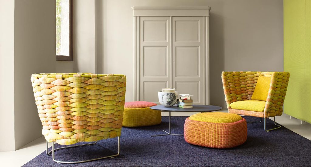 Two yellow Ami Indoor Armchairs. Structure upholstery of woven fabric, seat cushion of fabric, structure and leg in steel in a living room.