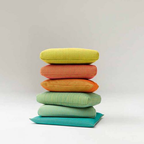 Six Indoor Cushions, upholstery, one in blue, two in green, one in orange, one in red and one in yellow on a white background.