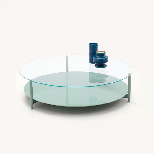 Harvey side table, base and legs in blue heartwood, lower surface in in blue fiber, top in transparent glass on a white background.