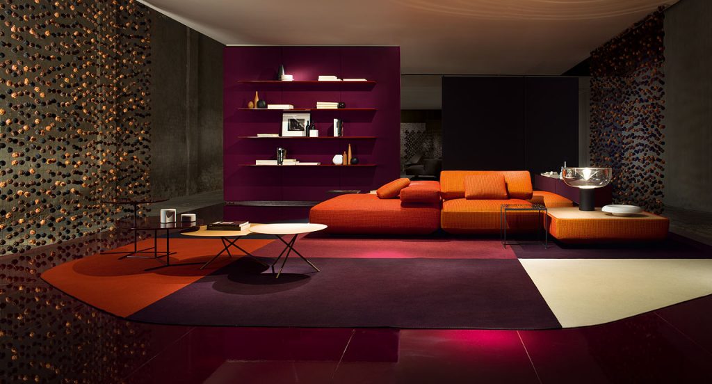Agio Modular sofa composed of large platforms, backrest can be adjusted, all upholstered in orange fabric in a living room.