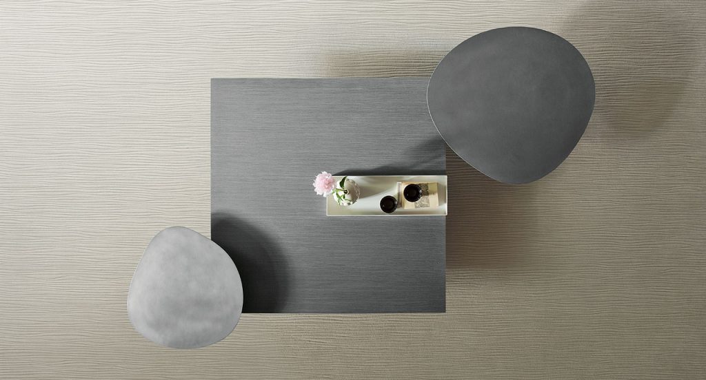 Kanji Coffee Table, top in dark wooden and white metal tray, two legs in black wood in a living room.