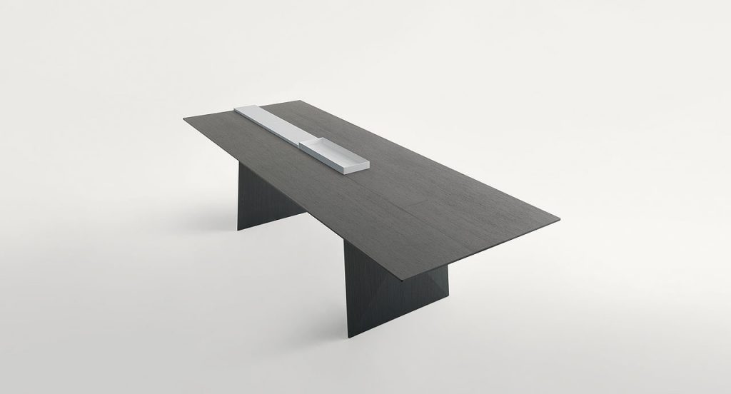 Black Kanji Dining Table, top in natural fibreboard and two legs in wood and two white metal trays on a white background.