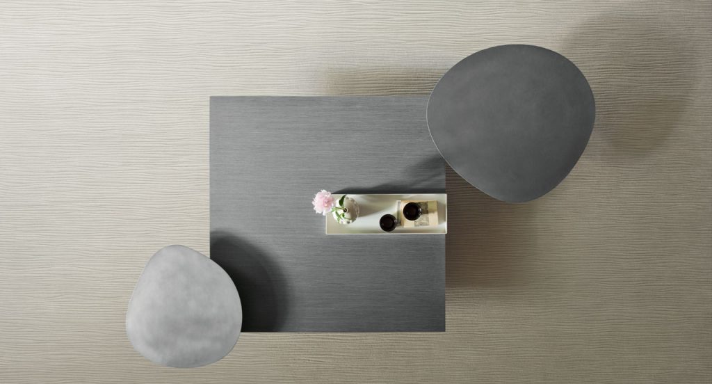 Two Lever Indoor Coffee Tables, top in grey and three legs in grey steel in a living room.