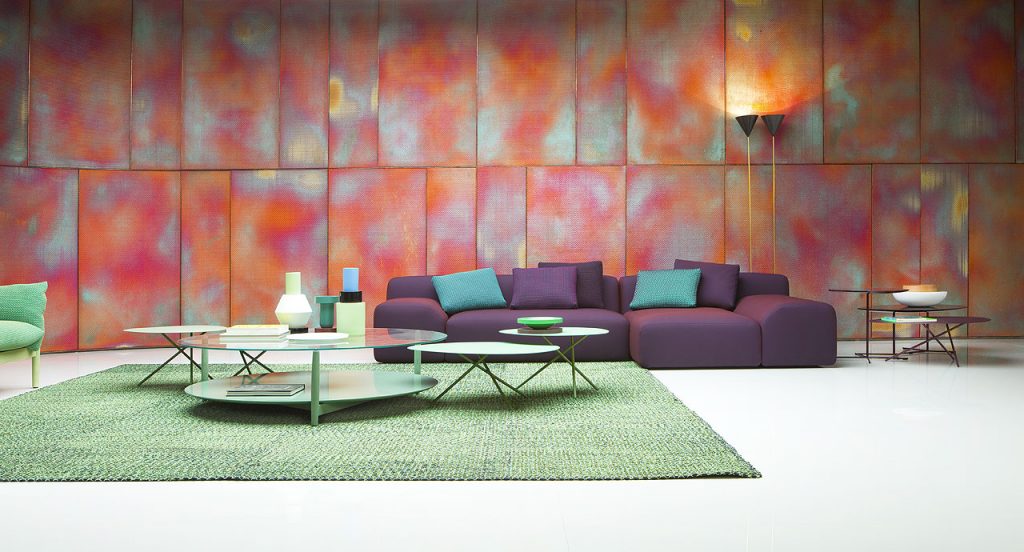 Six Lever Indoor Coffee Tables, top and three legs in stee, three in green and three in purple in a living room.