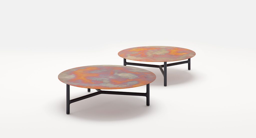 Two Nesso Indoor Coffee Tables, legs structure in black aluminium , top in copper on a white background.