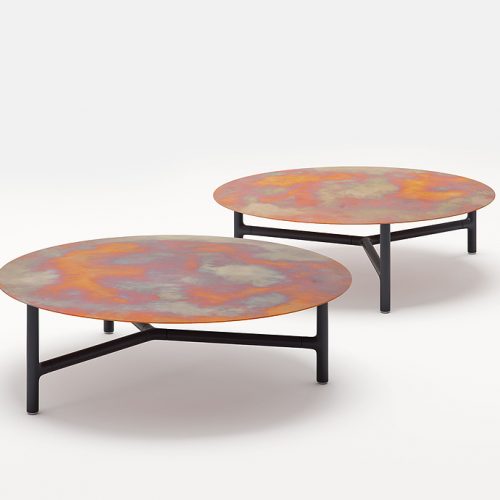 Two Nesso Indoor Coffee Tables, legs structure in black aluminium , top in copper on a white background.