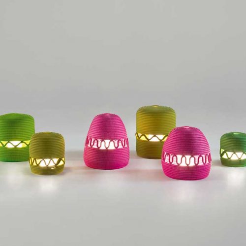 Six led Agadir lanterns made of rope cord in a spiral-like pattern, two in pink, two in yellow and two in green on a white background.