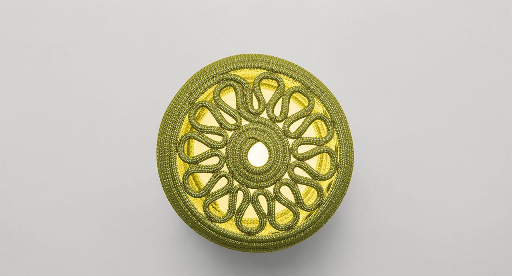 Led Agadir lantern made of yellow rope cord in a spiral-like pattern on a white background.