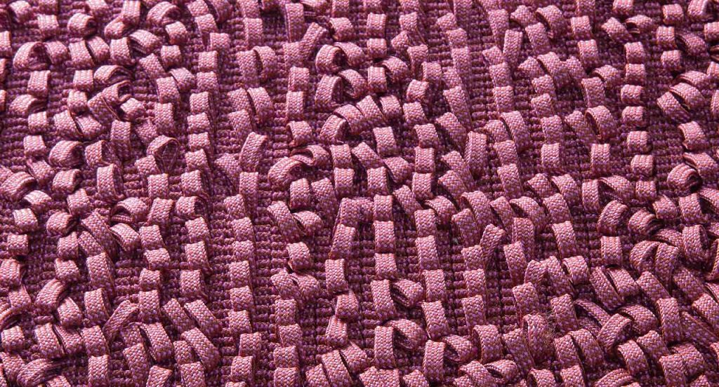 Air rug, texture of pink boucle stitches made of rope braid.