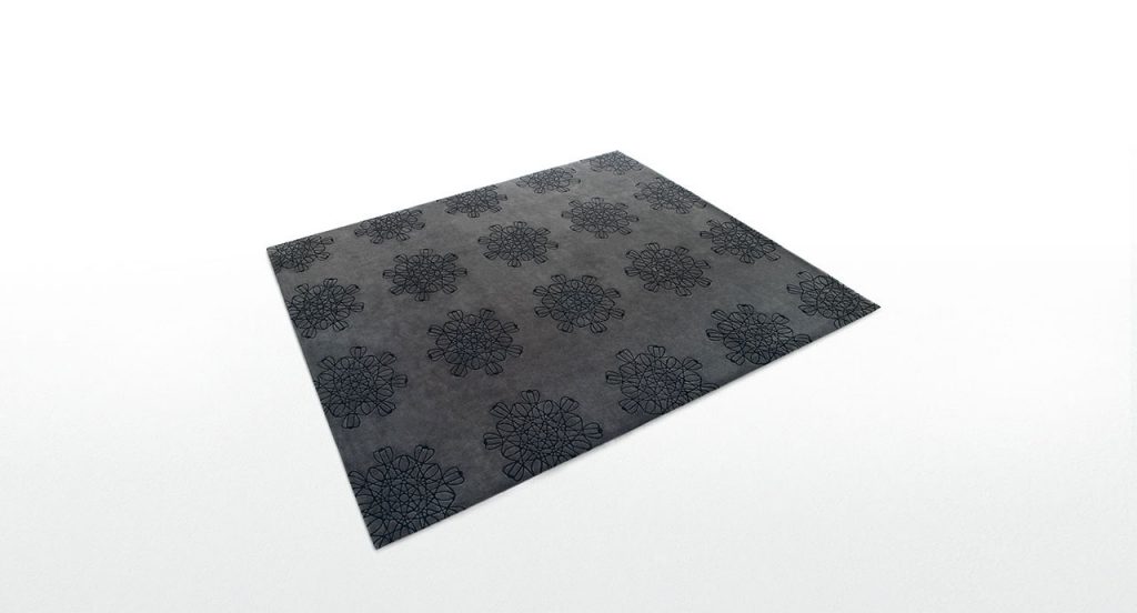 Arabesque rug made of black wool with floral patterns in an orthogonal placement on a white background.