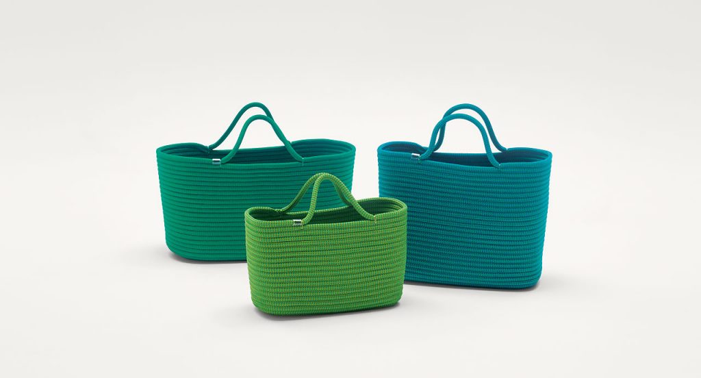 Three Bags made by shaping rope cord, two in green and one in blue on a white background.