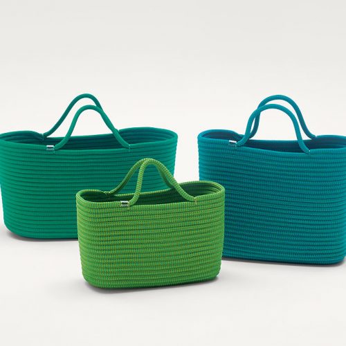 Three Bags made by shaping rope cord, two in green and one in blue on a white background.