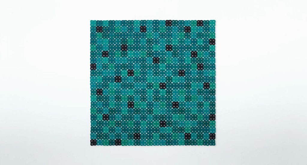 Bisanzio rug made of blue, green and black octagonal module cords on a white background.