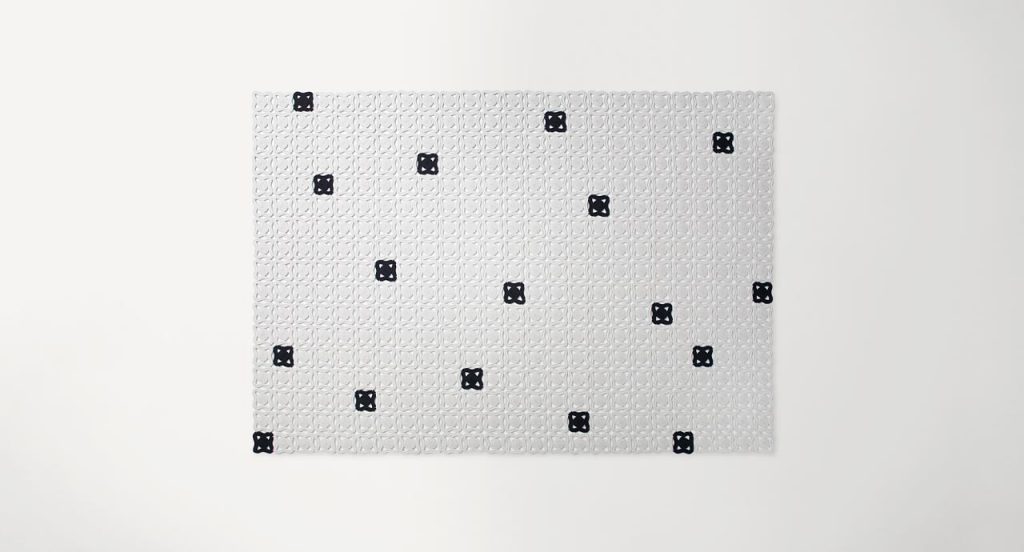 Bisanzio rug made of black and white octagonal module cords on a white background.
