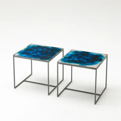 Two Cocci side tables, black steel frame, blue square ceramic top in a white background.