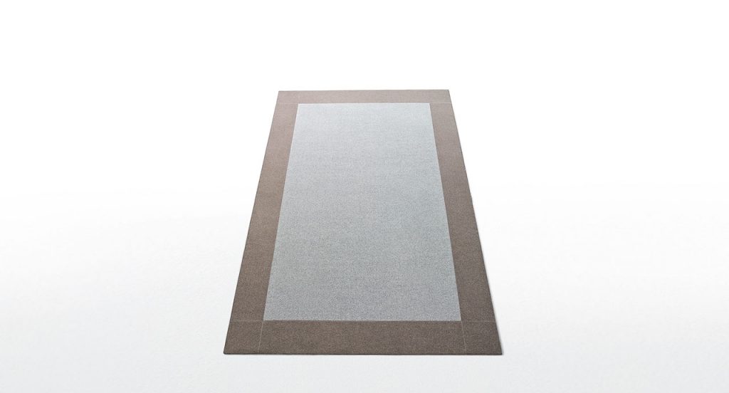 Rectangle Cornice 25 rug made of grey ad brown felt on a white background.