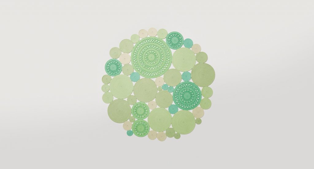 Cosmo rug, made of green and white round modules on a white background.