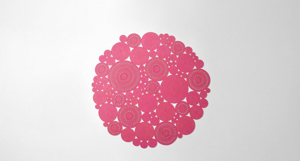 Cosmo rug, made of pink round modules on a white background.