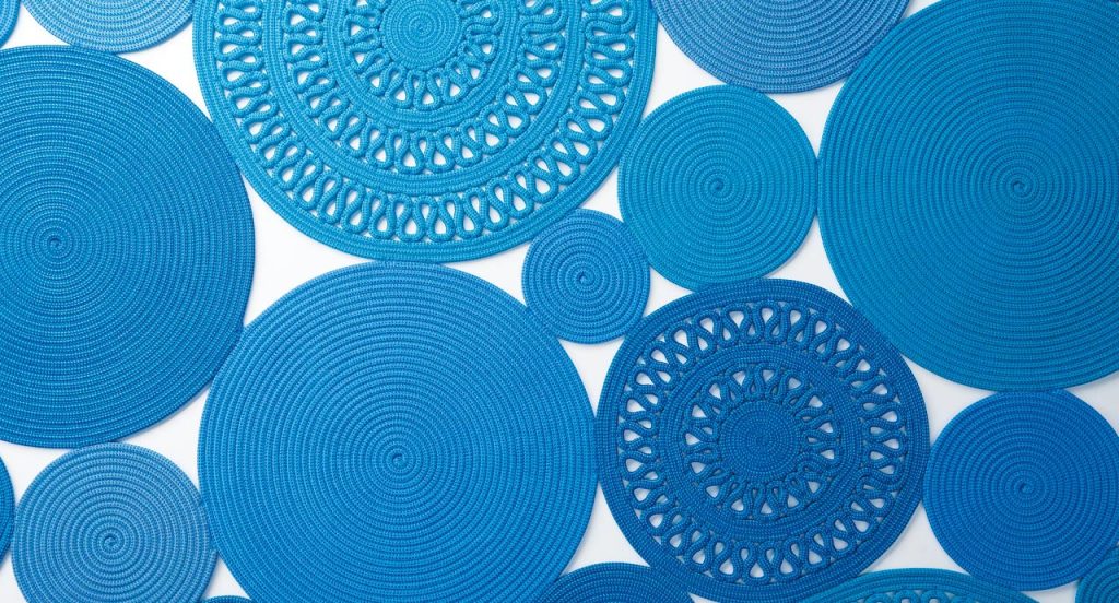Cosmo rug, made of blue round modules on a white background.