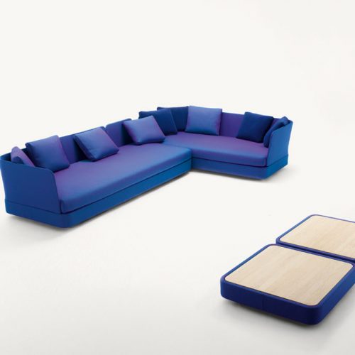 Two Cove Sectionals, upholstered in blue purple fabrics on a white background.