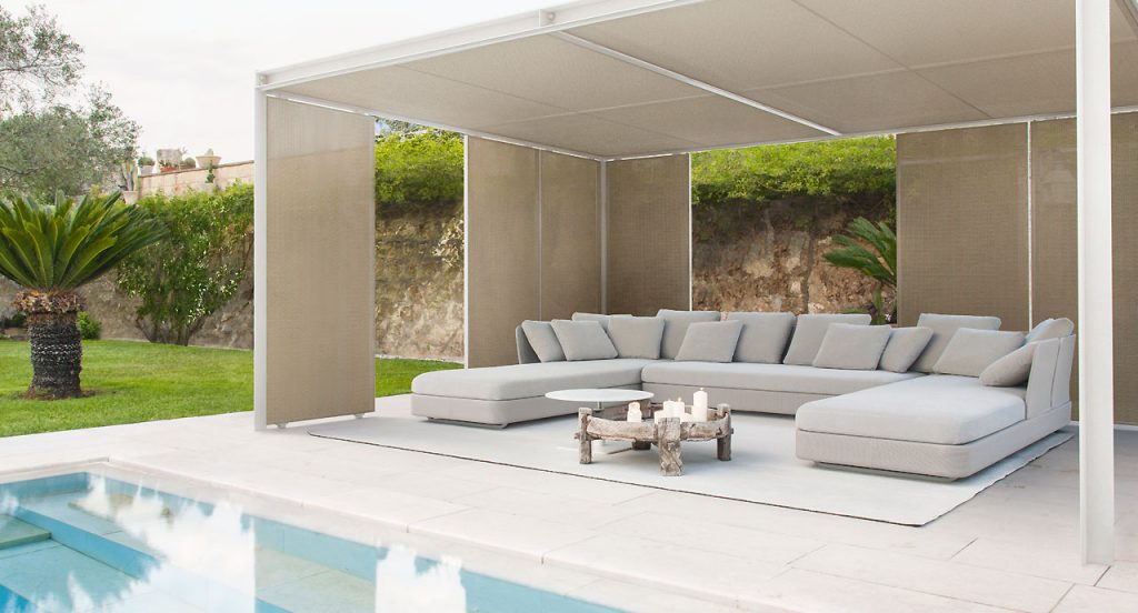Three Cove Sectionals, upholstered in grey fabrics, cushion in white fabrics in a terrace.