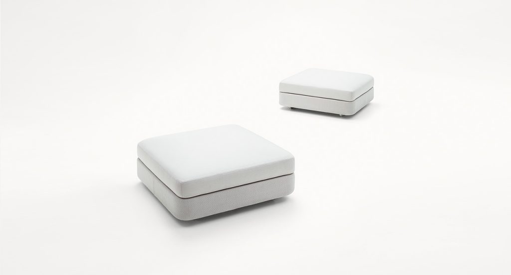 Two Square Cove Poufs, white upholstey on a white background.