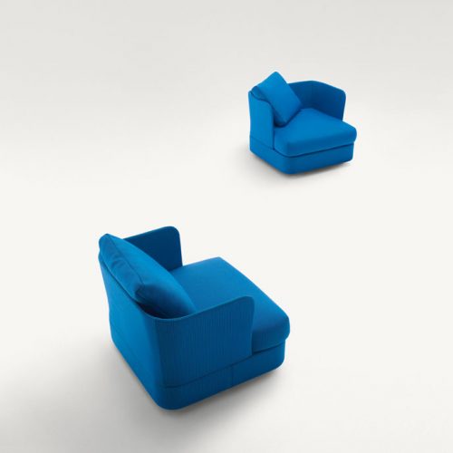 Two Cove Armchairs, upholstered in blue fabrics on a white bakcground.