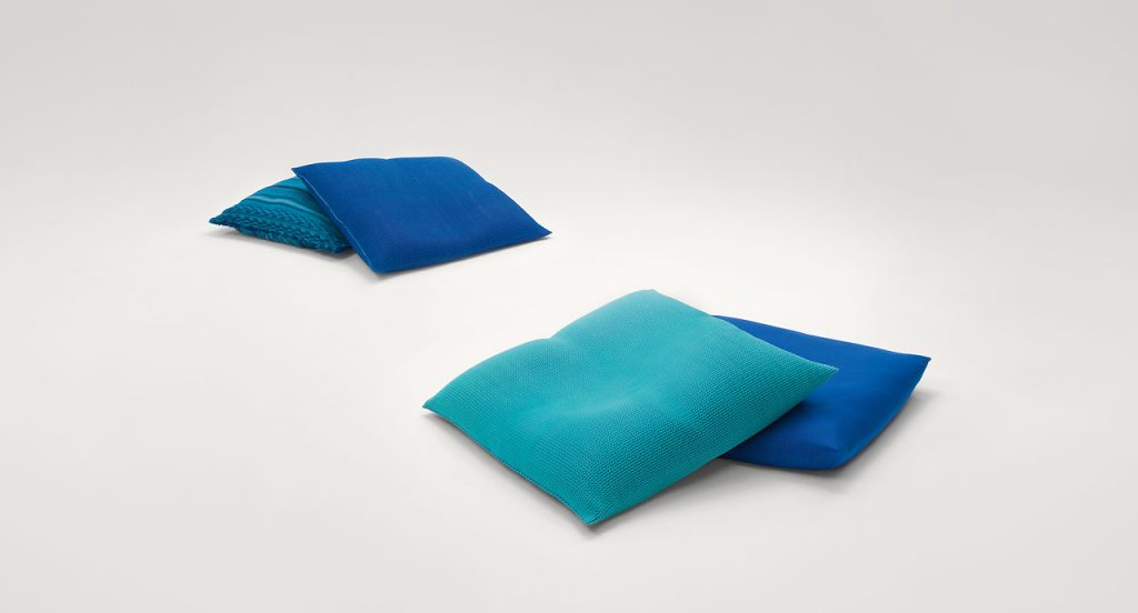 Four Outdoor Cushions with blue upholstery on a white background.