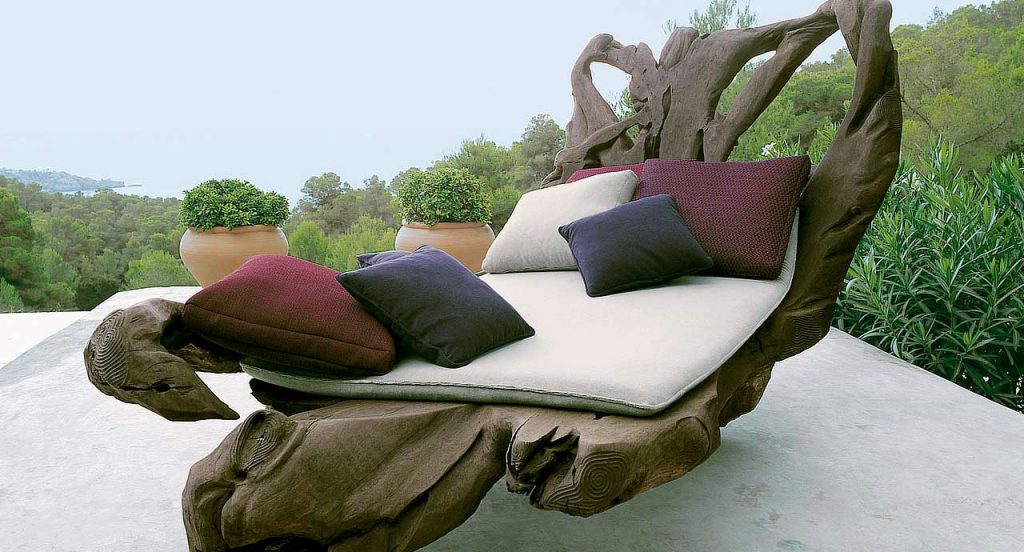 Fives Outdoor Cushions with upholstery, two in red, two in black and one in white in a terrace.