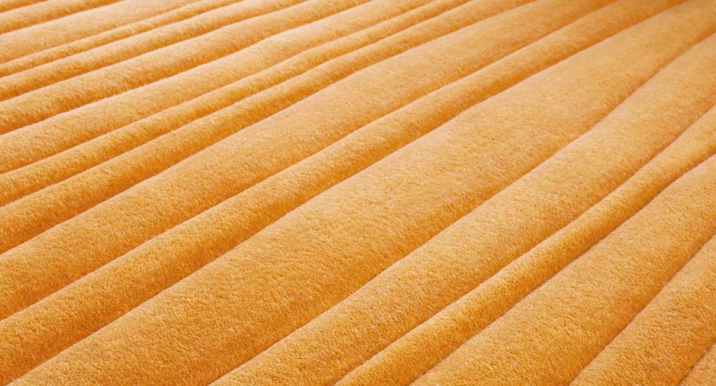 Orange Dune rug with irregular lines like pattern.