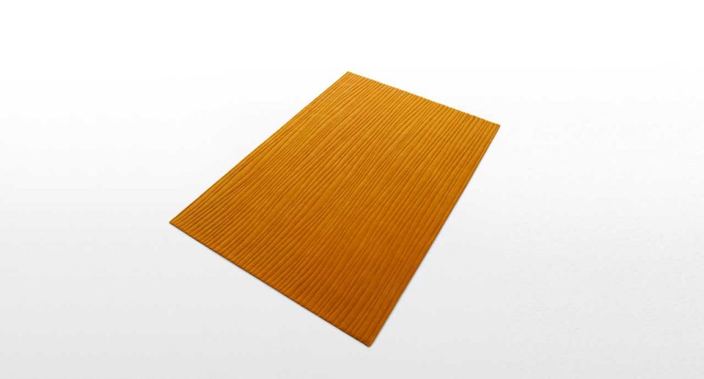 Orange Dune rug with irregular lines like pattern on a white background.