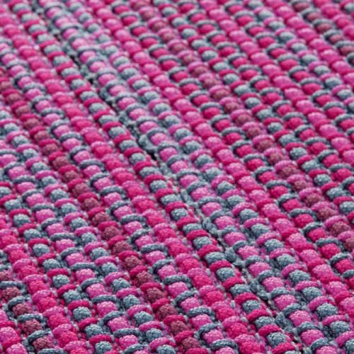 Echo rug made of grey and pink woven strips.
