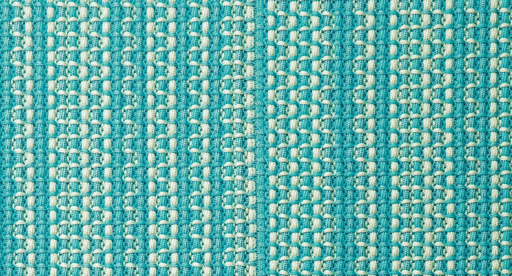 Echo rug made of blue and white woven strips.