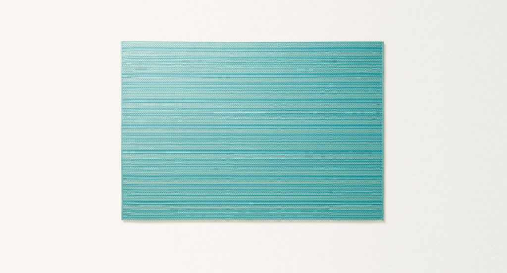 Echo rug made of blue and white woven strips on a white background.