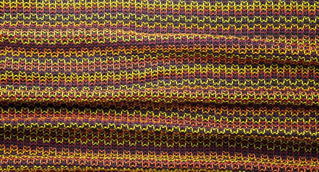 Farniente hammock made of red, yellow, orange, and purple fabric.