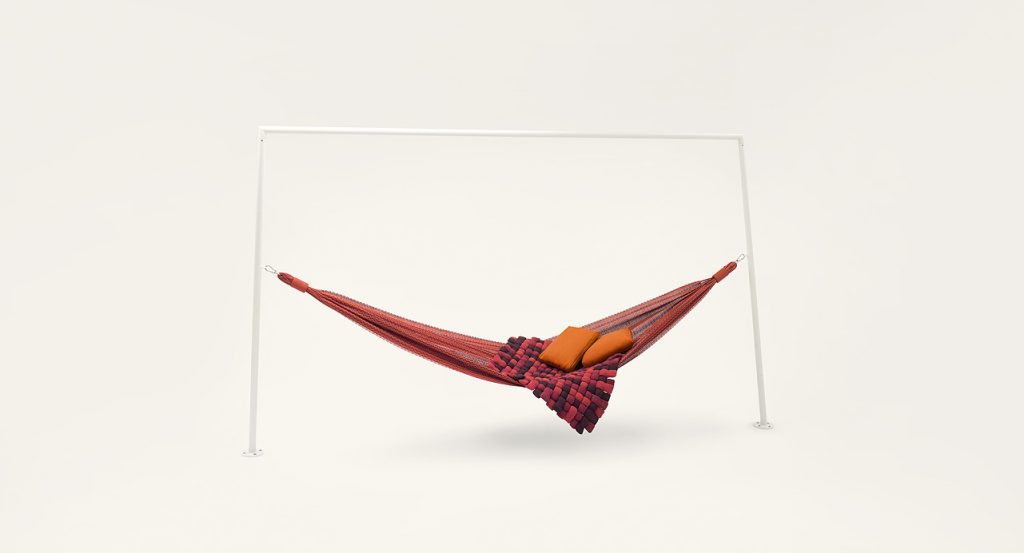 Farniente hammock made of red, yellow, orange, and purple fabric on a white background.