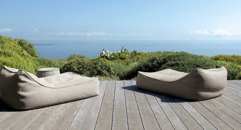 Two Float Chaises, upholstery in beige fabric in a terrace.