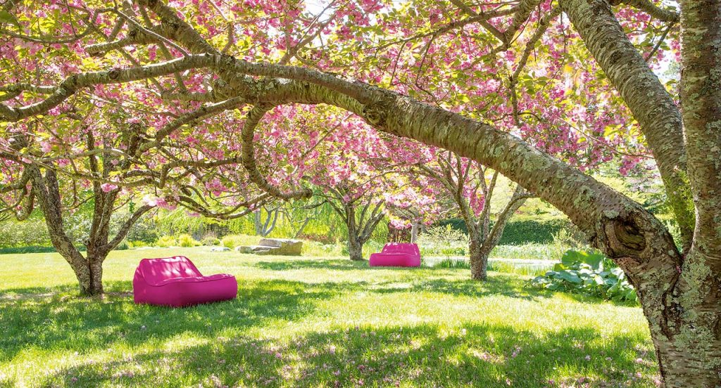 Two Float Chaises, upholstery in pink fabric in a garden.