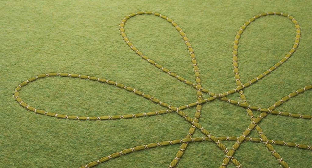 Green Flower rug made of felt, the design consists of flowers embroidered in relief.