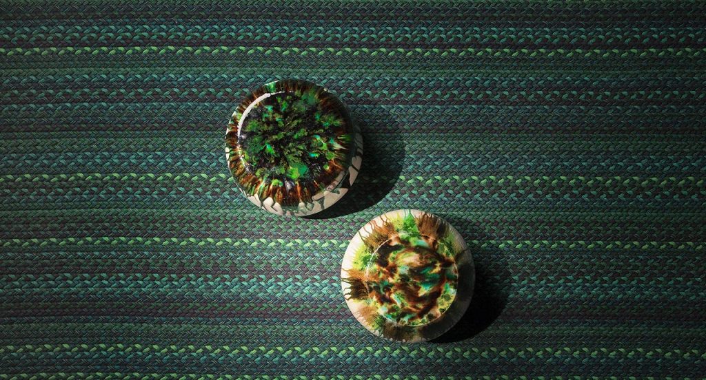 Flutti rug made of green and black braids of wool cords in a living room.