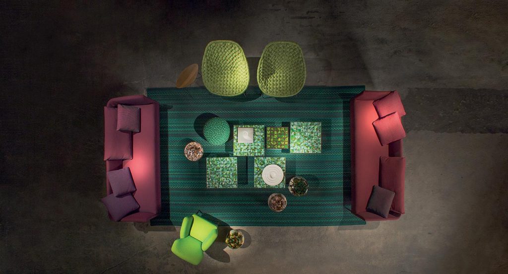 Flutti rug made of green and black braids of wool cords in a living room.