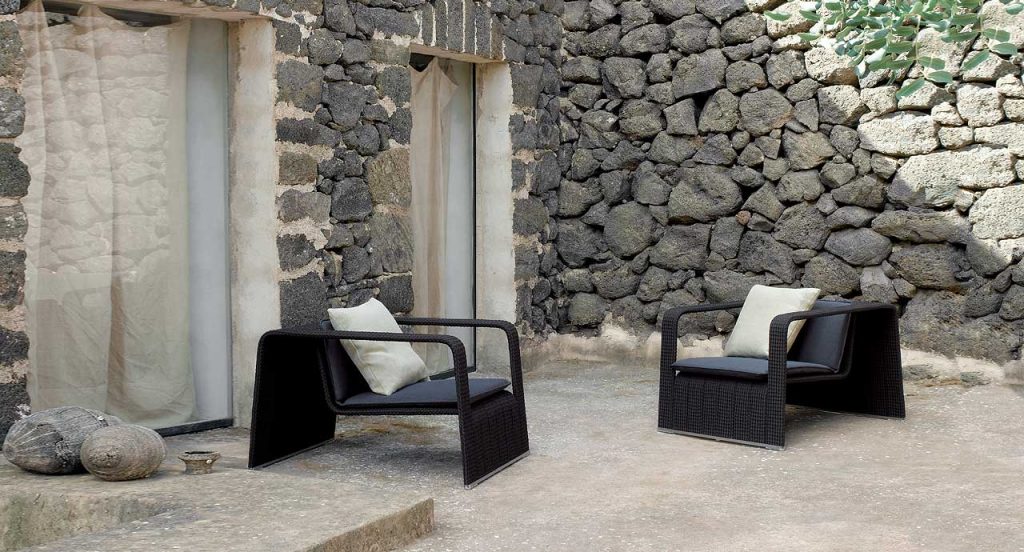 Two black Frame Armchairs, upholstery in rope braids and two cushions in a terrace.