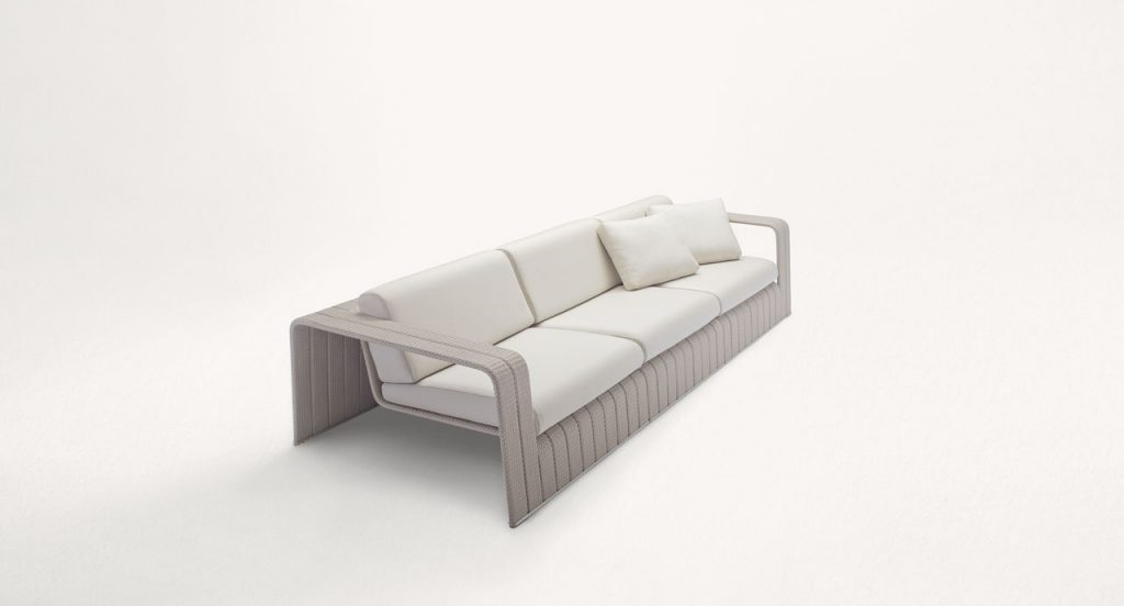 Frame Sectional sofa, upholstery in beige rope braids with four white cushions on a white background.