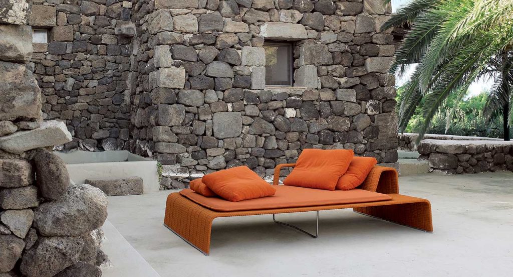 Orange Frame Chaise, upholstey of rope braids, seat pad and cushion in a terrace.