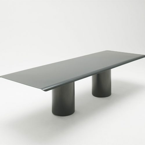 Rectangular Gon Dining Table of black steel with two legs on a white background.