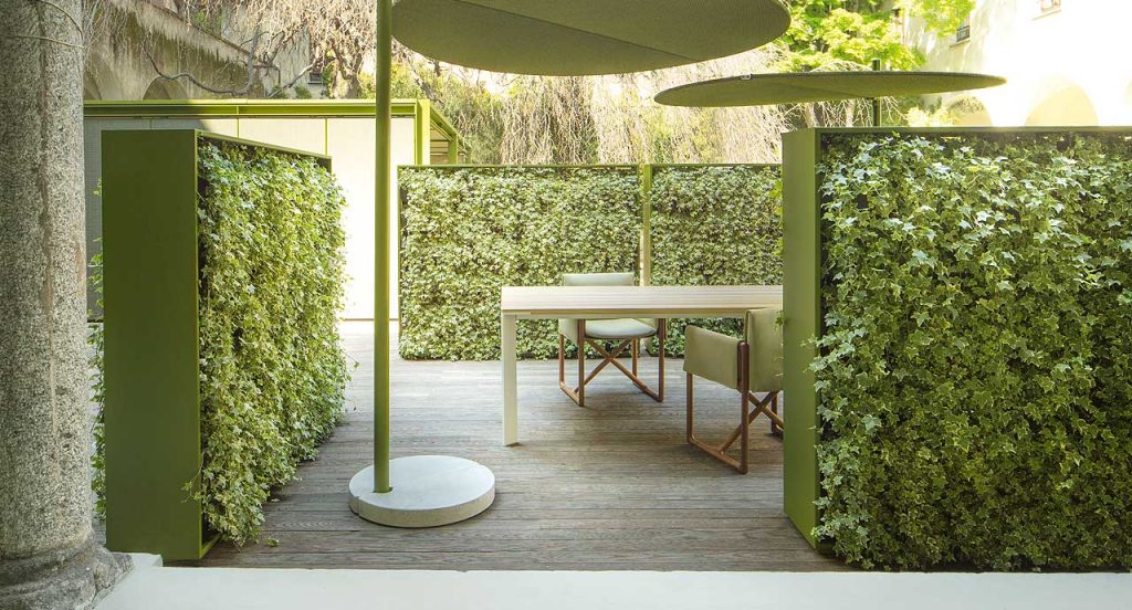 Three Greenery green walls, structure in green steel, planters in plastic in a garden.
