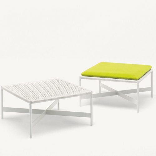 Two white Heron Stools, structure and four legs in steel, upholstery in rope cord, cushion in green on a white background.