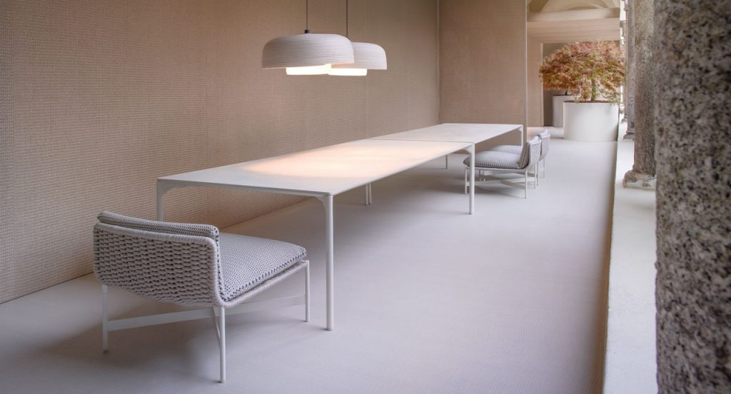 Three white Heron Stools, structure and four legs in steel, upholstery in rope cord, cushion in grey in dining room.